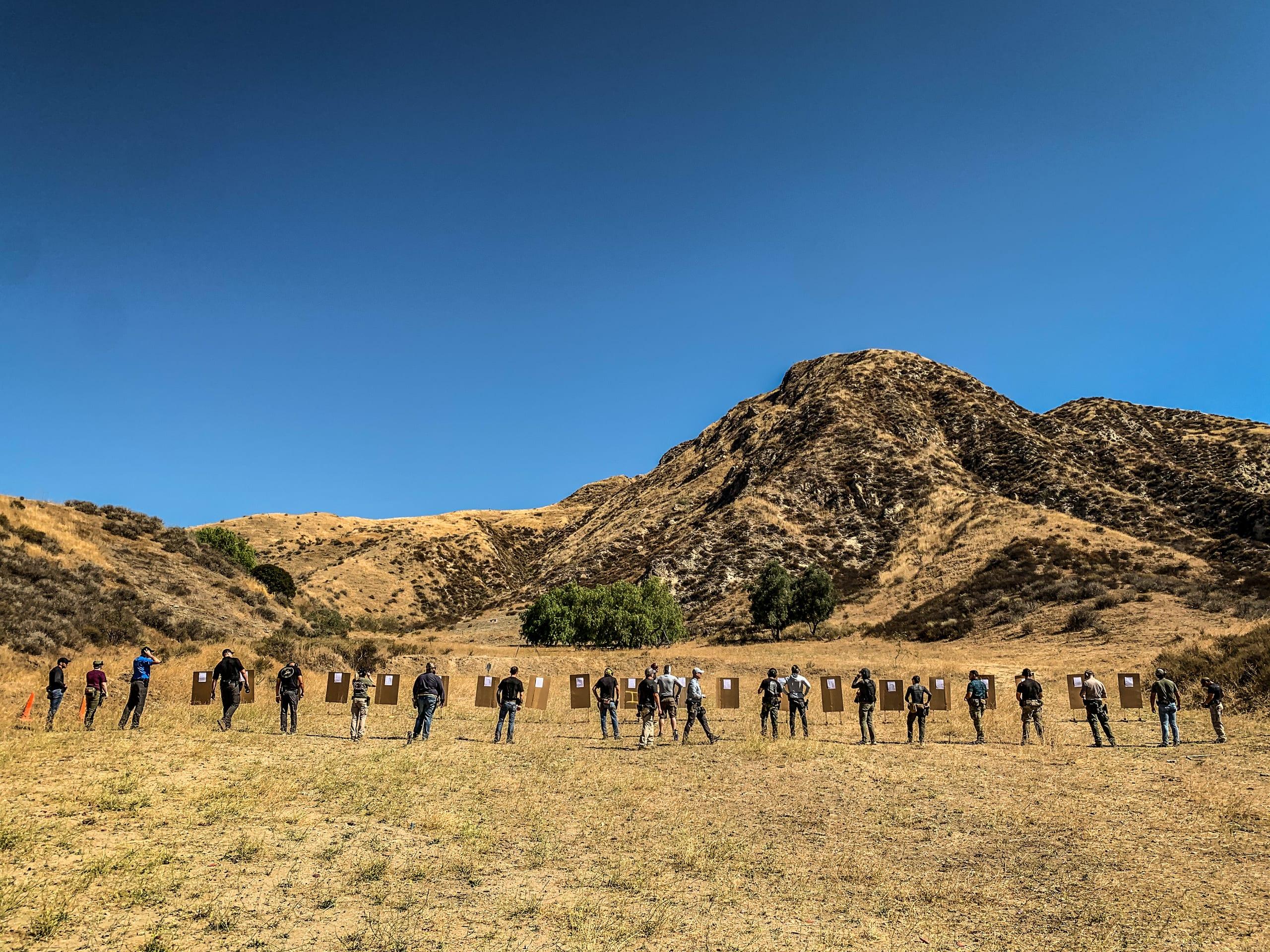 A wide firing line running a serial with mountains behind