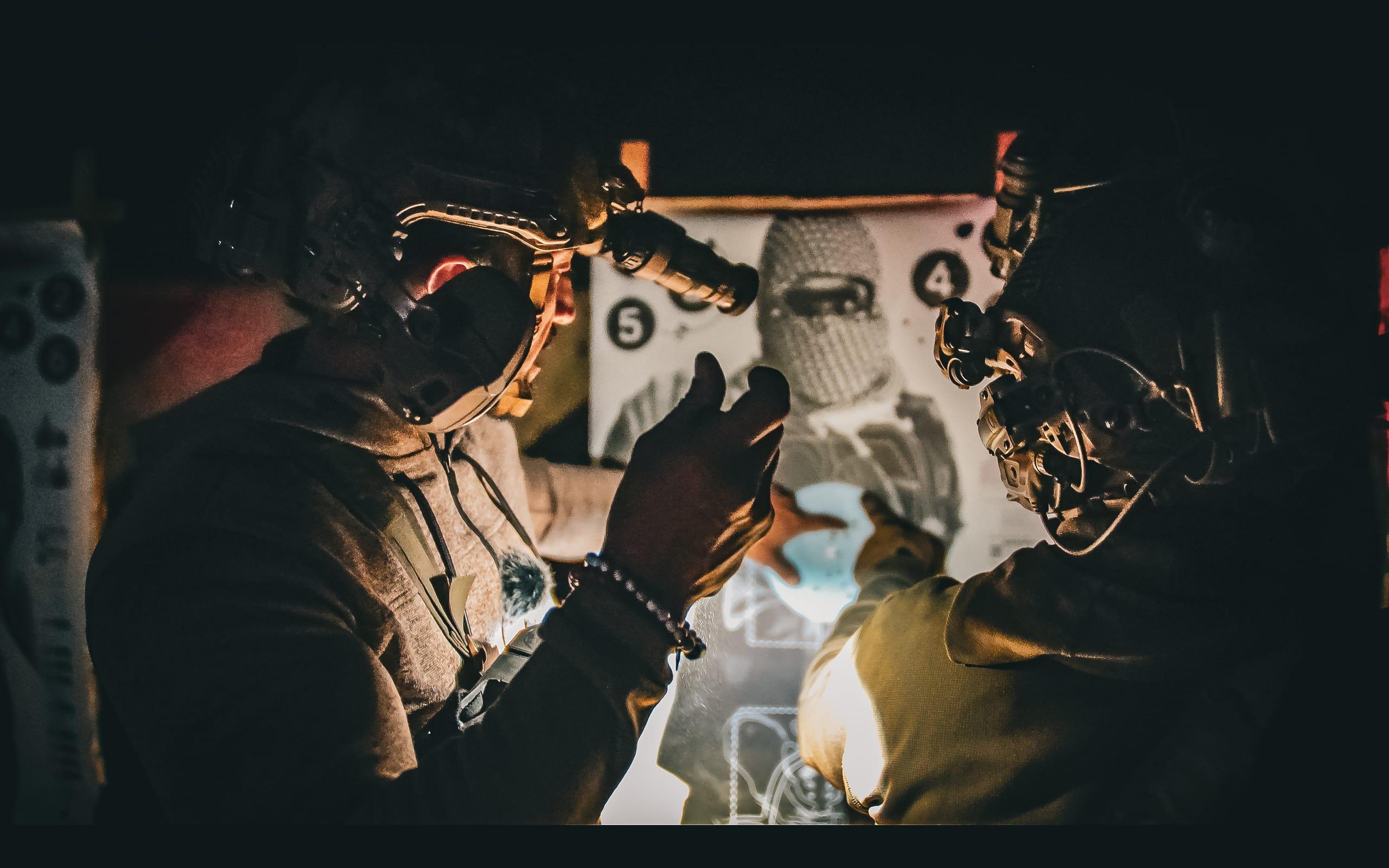 Team stacked at a doorway during a night close-quarters drill