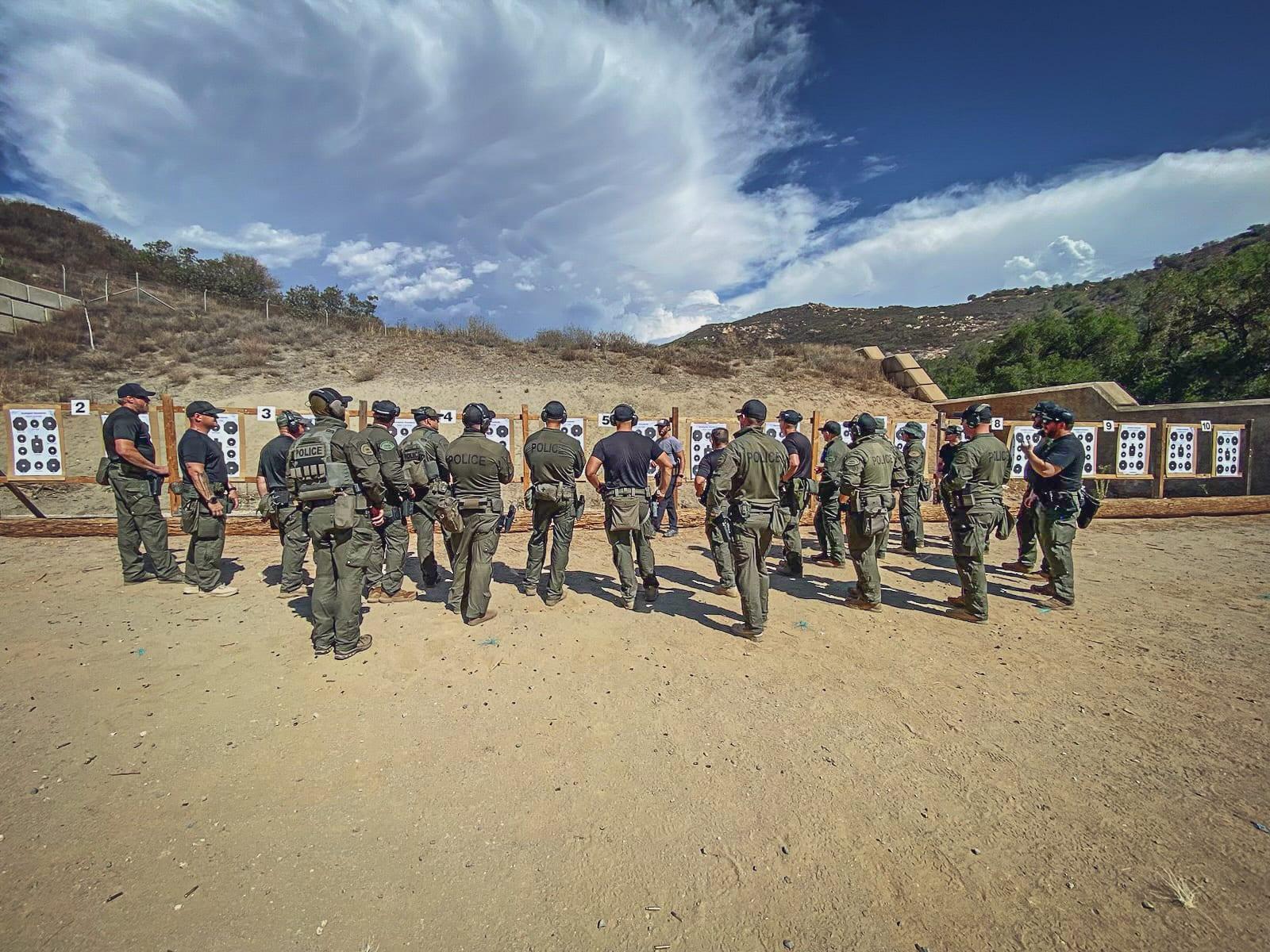 Instructors working a line of shooters on an outdoor range
